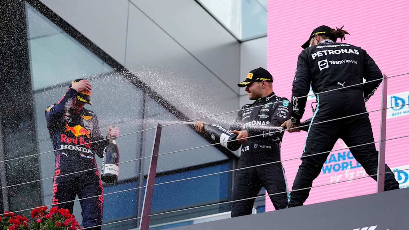 SPIELBERG, AUSTRIA - JUNE 27: Race winner Max Verstappen of Netherlands and Red Bull Racing, second placed Lewis Hamilton of Great Britain and Mercedes GP and third placed Valtteri Bottas of Finland and Mercedes GP celebrate on the podium during the F1 Grand Prix of Styria at Red Bull Ring on June 27, 2021 in Spielberg, Austria. (Photo by Darko Vojinovic - Pool/Getty Images)