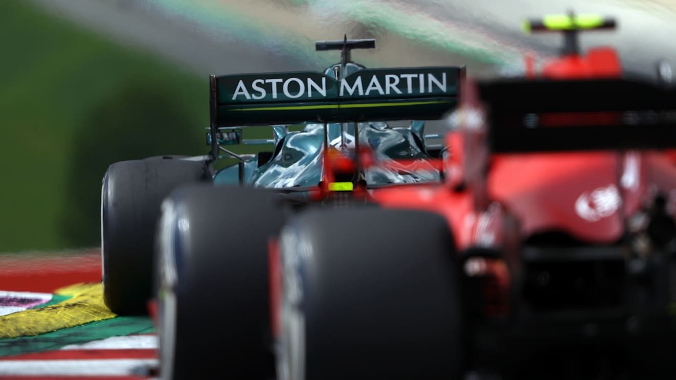 SPIELBERG, AUSTRIA - JUNE 27: Lance Stroll of Canada driving the (18) Aston Martin AMR21 Mercedes leads Carlos Sainz of Spain driving the (55) Scuderia Ferrari SF21 during the F1 Grand Prix of Styria at Red Bull Ring on June 27, 2021 in Spielberg, Austria. (Photo by Bryn Lennon/Getty Images)