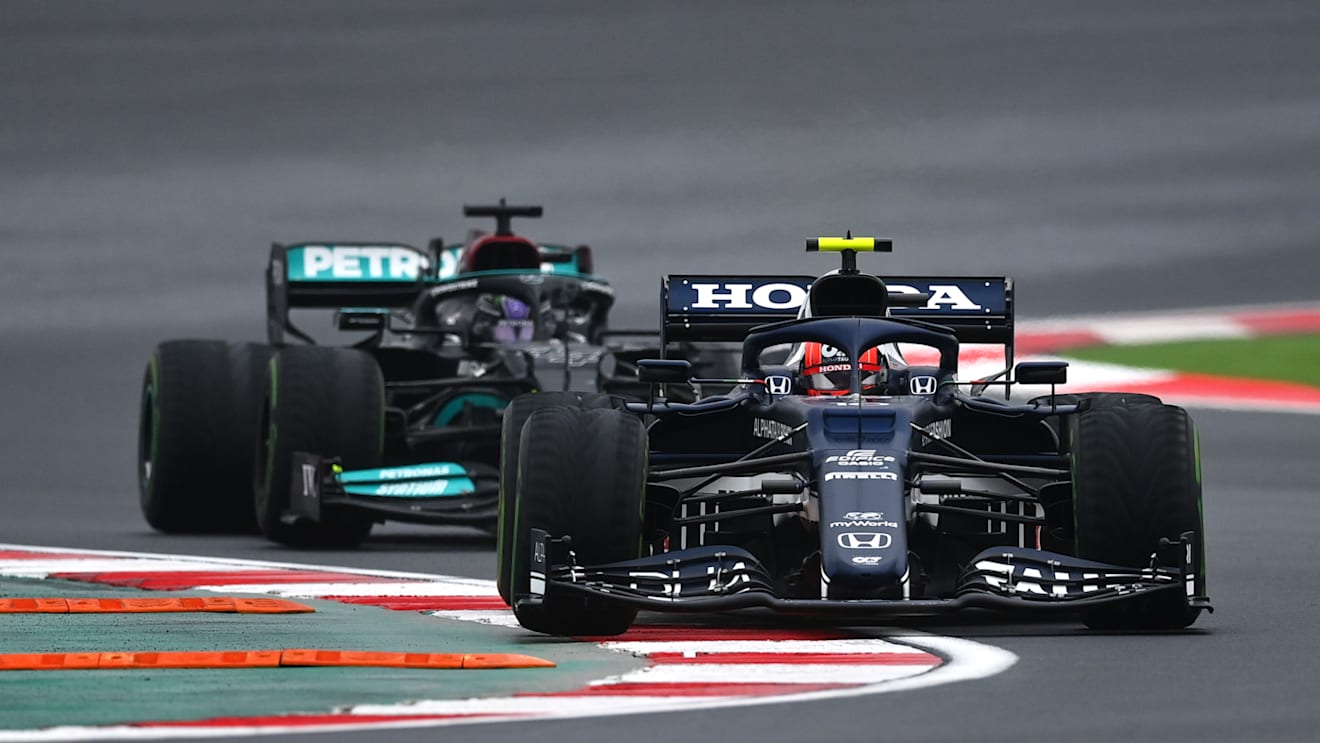 ISTANBUL, TURKEY - OCTOBER 10: Pierre Gasly of France driving the (10) Scuderia AlphaTauri AT02 Honda leads Lewis Hamilton of Great Britain driving the (44) Mercedes AMG Petronas F1 Team Mercedes W12 during the F1 Grand Prix of Turkey at Intercity Istanbul Park on October 10, 2021 in Istanbul, Turkey. (Photo by Dan Mullan/Getty Images)