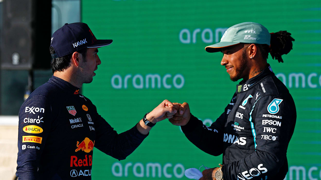 AUSTIN, TEXAS - OCTOBER 23: Second place qualifier Lewis Hamilton of Great Britain and Mercedes GP and third place qualifier Sergio Perez of Mexico and Red Bull Racing celebrate in parc ferme during qualifying ahead of the F1 Grand Prix of USA at Circuit of The Americas on October 23, 2021 in Austin, Texas. (Photo by Jared C. Tilton/Getty Images)