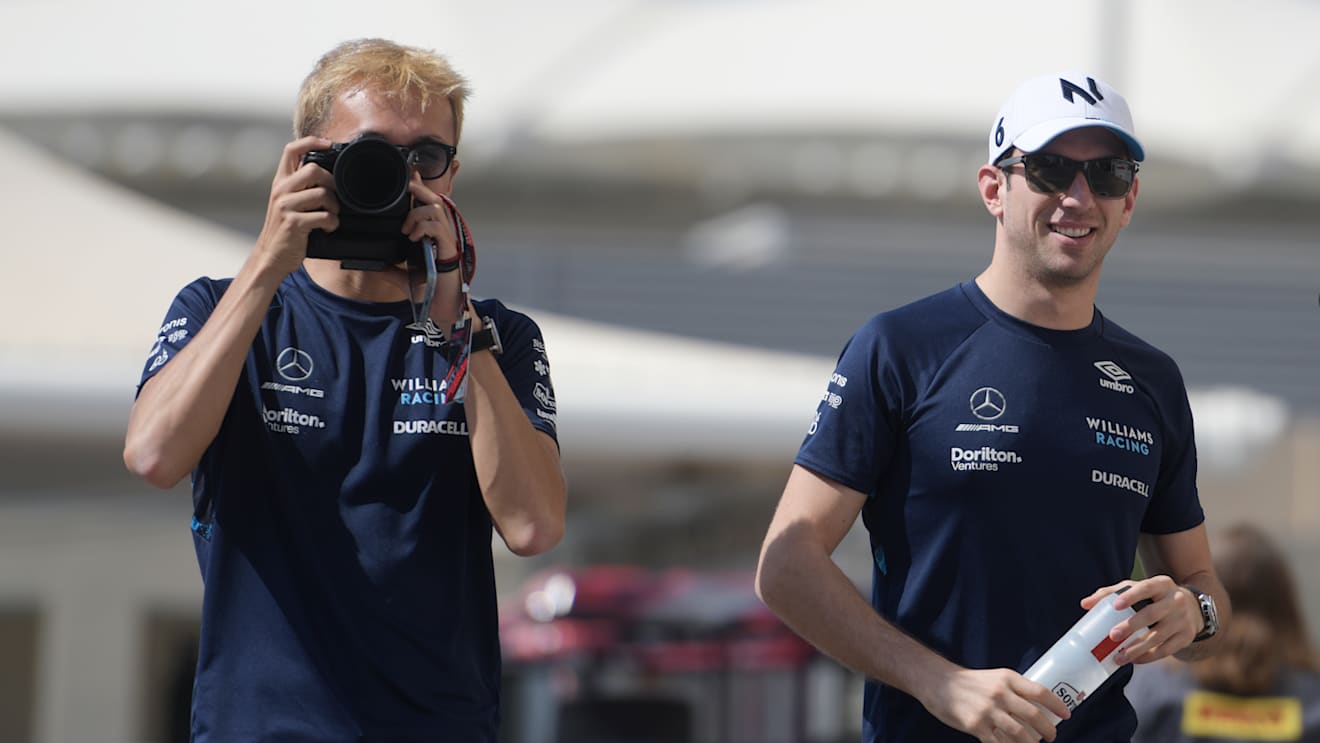 ABU DHABI, UNITED ARAB EMIRATES - NOVEMBER 18: Alexander Albon of Thailand and Williams and Nicholas Latifi of Canada and Williams walk in the paddock prior to practice ahead of the F1 Grand Prix of Abu Dhabi at Yas Marina Circuit on November 18, 2022 in Abu Dhabi, United Arab Emirates. (Photo by Rudy Carezzevoli/Getty Images)