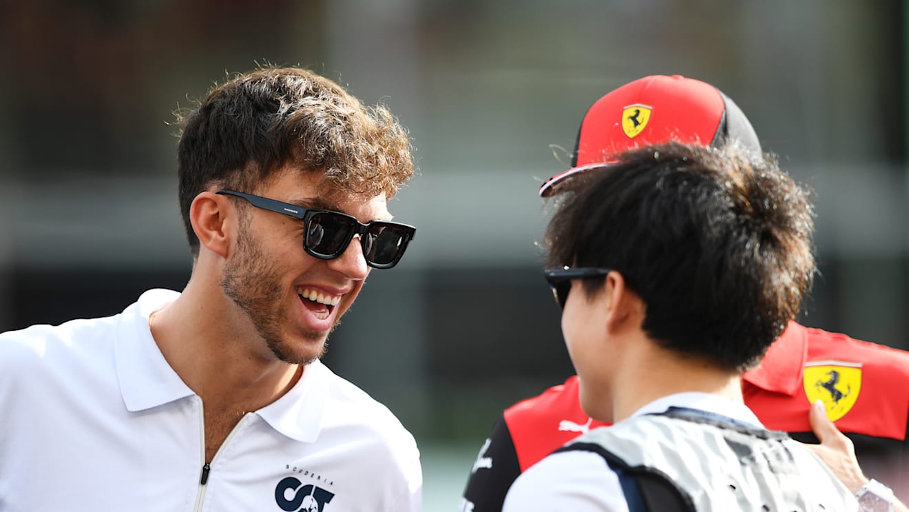 ABU DHABI, UNITED ARAB EMIRATES - NOVEMBER 20: Pierre Gasly of France and Scuderia AlphaTauri, Yuki Tsunoda of Japan and Scuderia AlphaTauri and Charles Leclerc of Monaco and Ferrari talk on the drivers parade prior to the F1 Grand Prix of Abu Dhabi at Yas Marina Circuit on November 20, 2022 in Abu Dhabi, United Arab Emirates. (Photo by Rudy Carezzevoli/Getty Images)