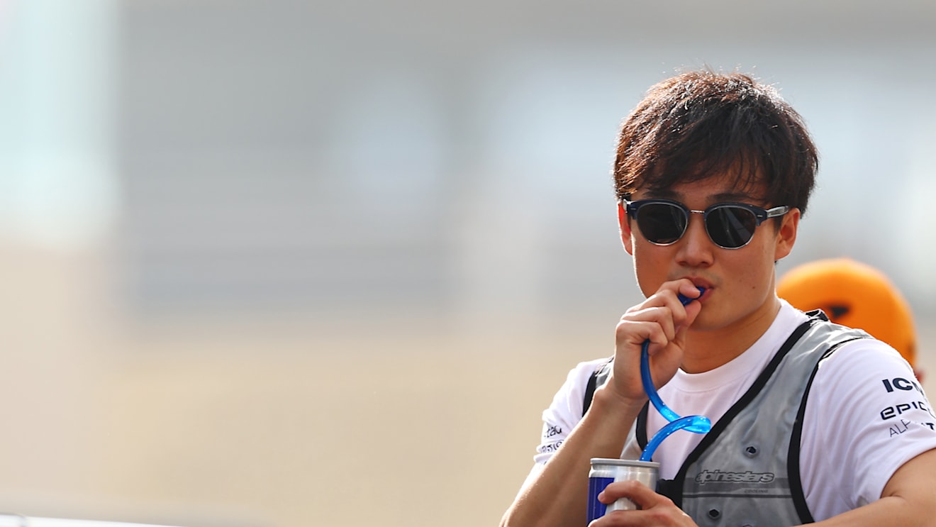 ABU DHABI, UNITED ARAB EMIRATES - NOVEMBER 20: Yuki Tsunoda of Japan and Scuderia AlphaTauri looks on from the drivers parade prior to the F1 Grand Prix of Abu Dhabi at Yas Marina Circuit on November 20, 2022 in Abu Dhabi, United Arab Emirates. (Photo by Mark Thompson/Getty Images)