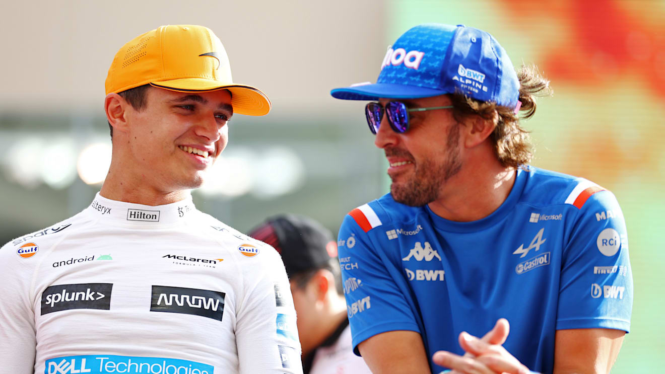 ABU DHABI, UNITED ARAB EMIRATES - NOVEMBER 20: Lando Norris of Great Britain and McLaren talks with Fernando Alonso of Spain and Alpine F1 on the drivers parade prior to the F1 Grand Prix of Abu Dhabi at Yas Marina Circuit on November 20, 2022 in Abu Dhabi, United Arab Emirates. (Photo by Bryn Lennon - Formula 1/Formula 1 via Getty Images)