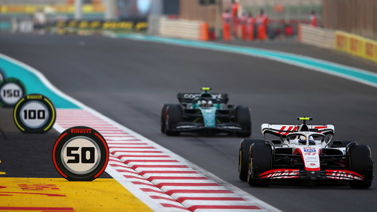 ABU DHABI, UNITED ARAB EMIRATES - NOVEMBER 20: Mick Schumacher of Germany driving the (47) Haas F1 VF-22 Ferrari leads Sebastian Vettel of Germany driving the (5) Aston Martin AMR22 Mercedes on their way to the grid prior to the F1 Grand Prix of Abu Dhabi at Yas Marina Circuit on November 20, 2022 in Abu Dhabi, United Arab Emirates. (Photo by Joe Portlock - Formula 1/Formula 1 via Getty Images)