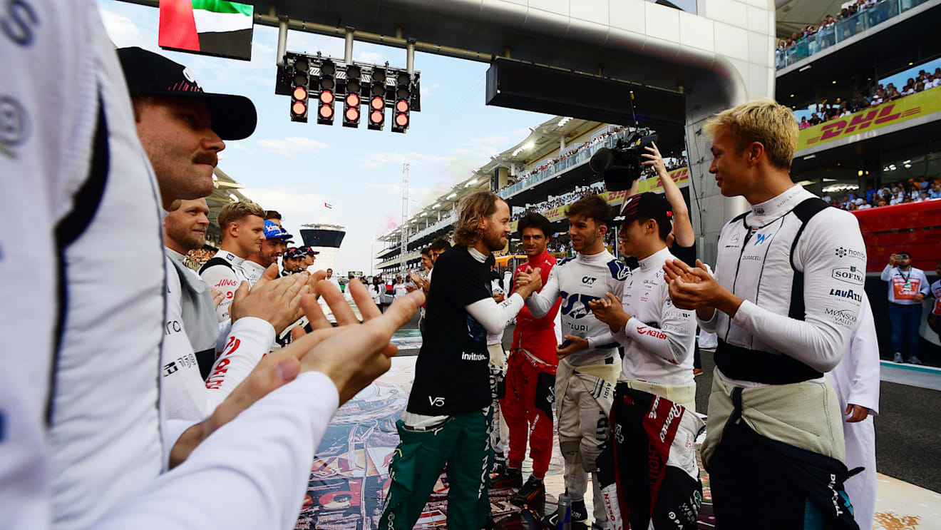 ABU DHABI, UNITED ARAB EMIRATES - NOVEMBER 20: Sebastian Vettel of Germany and Aston Martin F1 Team receives a guard of honour on the grid prior to the F1 Grand Prix of Abu Dhabi at Yas Marina Circuit on November 20, 2022 in Abu Dhabi, United Arab Emirates. (Photo by Mario Renzi - Formula 1/Formula 1 via Getty Images)
