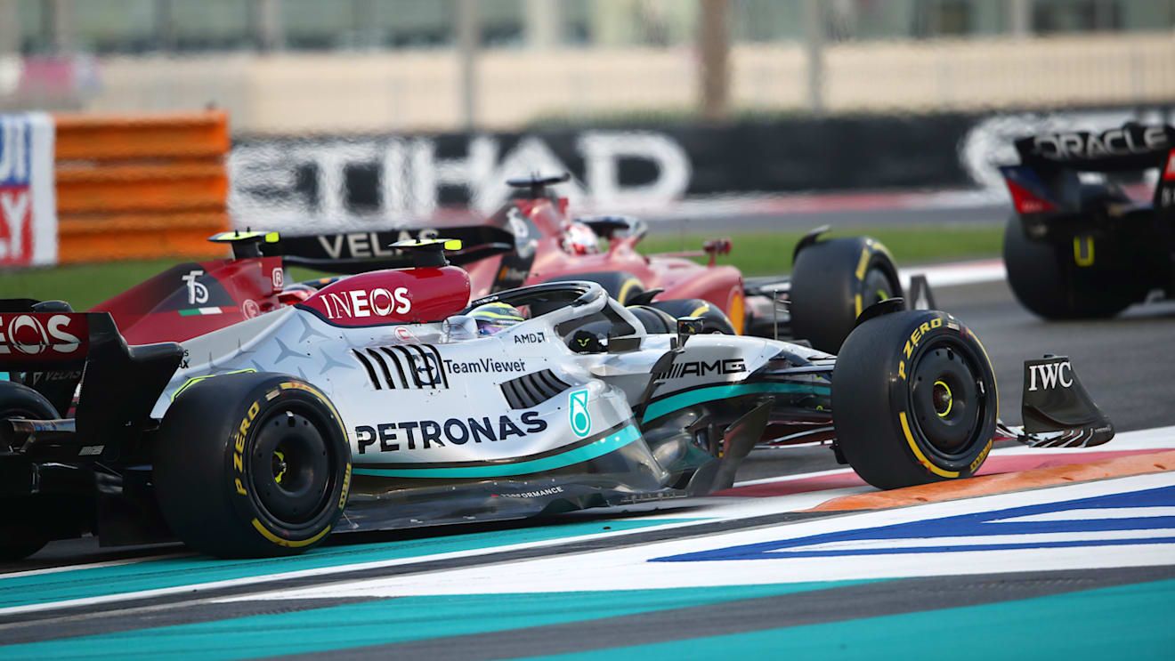ABU DHABI, UNITED ARAB EMIRATES - NOVEMBER 20: Lewis Hamilton of Great Britain driving the (44) Mercedes AMG Petronas F1 Team W13 runs wide as he battles on the track with Carlos Sainz of Spain driving (55) the Ferrari F1-75 during the F1 Grand Prix of Abu Dhabi at Yas Marina Circuit on November 20, 2022 in Abu Dhabi, United Arab Emirates. (Photo by Joe Portlock - Formula 1/Formula 1 via Getty Images)