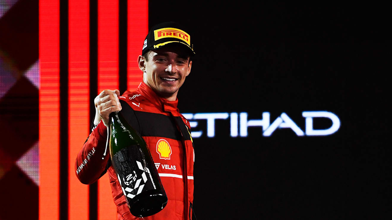 ABU DHABI, UNITED ARAB EMIRATES - NOVEMBER 20: Second placed Charles Leclerc of Monaco and Ferrari celebrates on the podium following the F1 Grand Prix of Abu Dhabi at Yas Marina Circuit on November 20, 2022 in Abu Dhabi, United Arab Emirates. (Photo by Rudy Carezzevoli/Getty Images)
