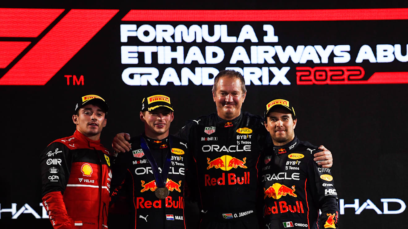ABU DHABI, UNITED ARAB EMIRATES - NOVEMBER 20: Race winner Max Verstappen of the Netherlands and Oracle Red Bull Racing, second placed Charles Leclerc of Monaco and Ferrari, Olaf Janssen, Red Bull Racing Team Member and Third placed Sergio Perez of Mexico and Oracle Red Bull Racing celebrate on the podium during the F1 Grand Prix of Abu Dhabi at Yas Marina Circuit on November 20, 2022 in Abu Dhabi, United Arab Emirates. (Photo by Rudy Carezzevoli/Getty Images)