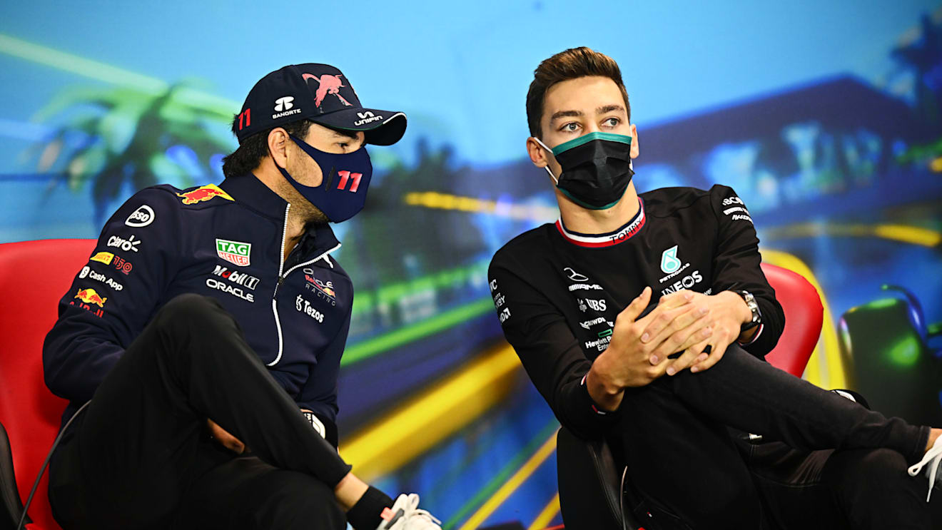 MELBOURNE, AUSTRALIA - APRIL 08: Sergio Perez of Mexico and Oracle Red Bull Racing and George Russell of Great Britain and Mercedes talk in the Drivers Press Conference prior to practice ahead of the F1 Grand Prix of Australia at Melbourne Grand Prix Circuit on April 08, 2022 in Melbourne, Australia. (Photo by Clive Mason/Getty Images)