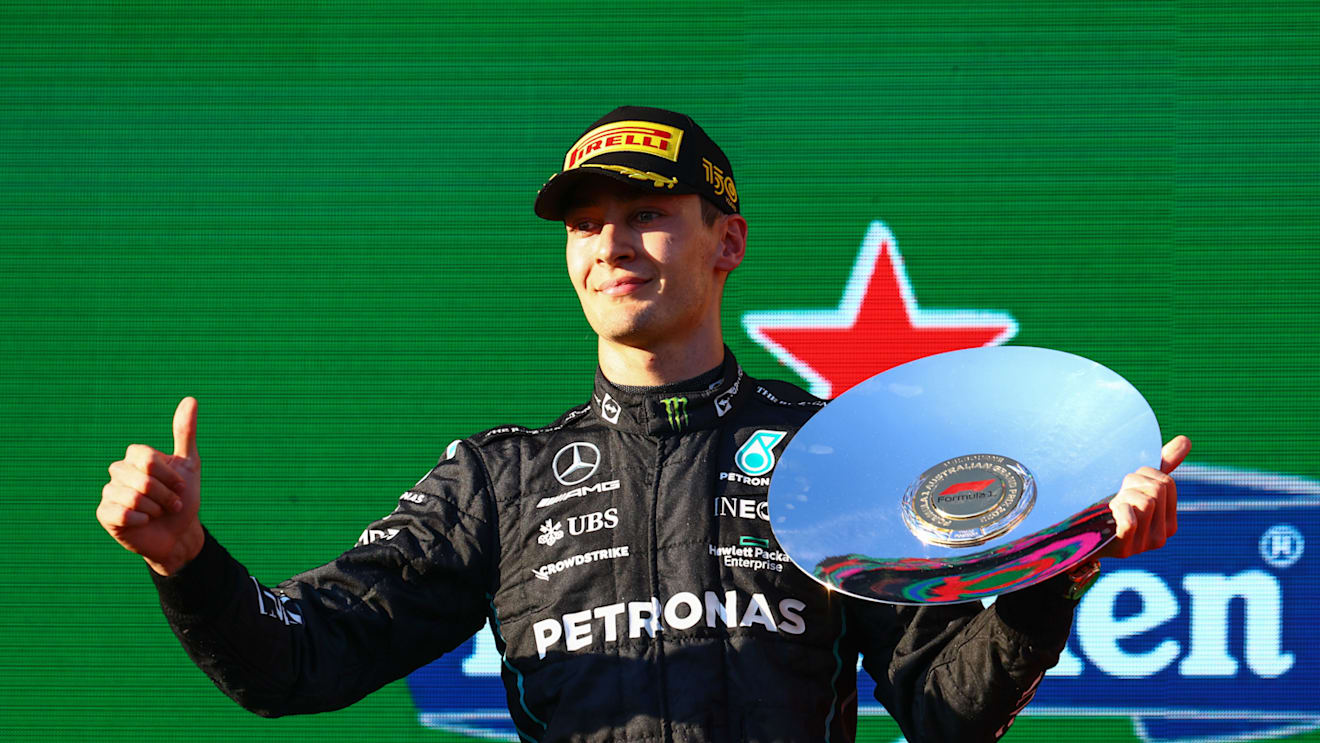 MELBOURNE, AUSTRALIA - APRIL 10: Third placed George Russell of Great Britain and Mercedes celebrates on the podium during the F1 Grand Prix of Australia at Melbourne Grand Prix Circuit on April 10, 2022 in Melbourne, Australia. (Photo by Mark Thompson/Getty Images)