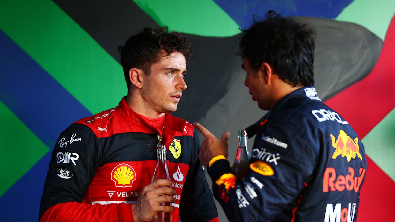 MELBOURNE, AUSTRALIA - APRIL 10: Race winner Charles Leclerc of Monaco and Ferrari and Second placed Sergio Perez of Mexico and Oracle Red Bull Racing talk in parc ferme during the F1 Grand Prix of Australia at Melbourne Grand Prix Circuit on April 10, 2022 in Melbourne, Australia. (Photo by Dan Istitene - Formula 1/Formula 1 via Getty Images)