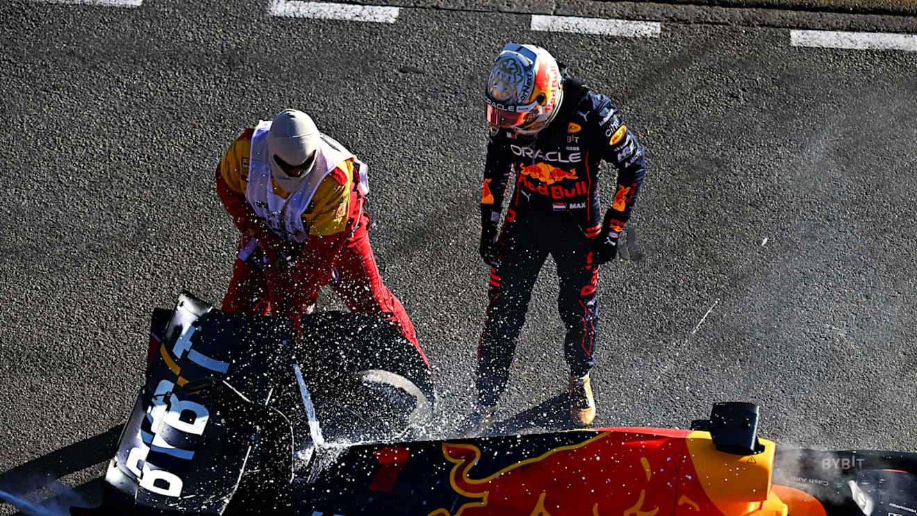 MELBOURNE, AUSTRALIA - APRIL 10: Max Verstappen of the Netherlands and Oracle Red Bull Racing and track marshals tend to the fire in his car after he retired from the race during the F1 Grand Prix of Australia at Melbourne Grand Prix Circuit on April 10, 2022 in Melbourne, Australia. (Photo by Clive Mason/Getty Images)