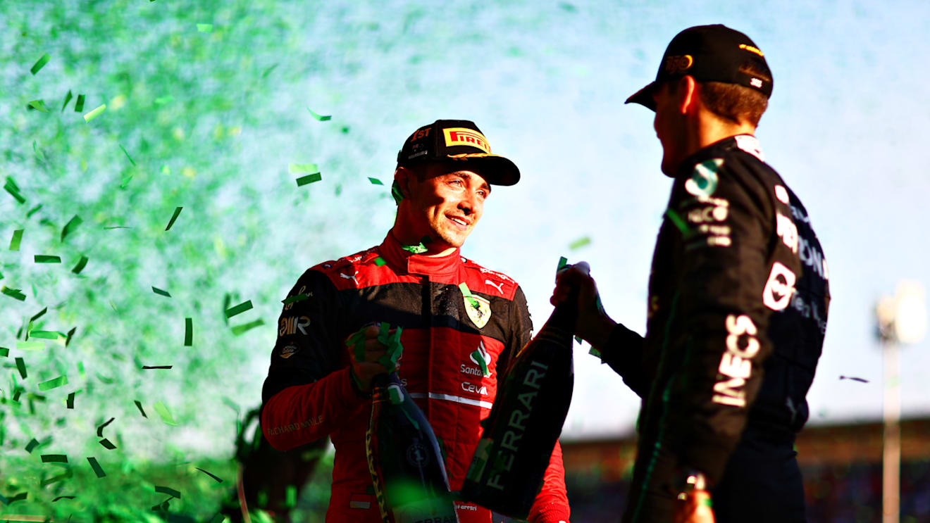 MELBOURNE, AUSTRALIA - APRIL 10: Race winner Charles Leclerc of Monaco and Ferrari and Third placed George Russell of Great Britain and Mercedes talk on the podium during the F1 Grand Prix of Australia at Melbourne Grand Prix Circuit on April 10, 2022 in Melbourne, Australia. (Photo by Dan Istitene - Formula 1/Formula 1 via Getty Images)