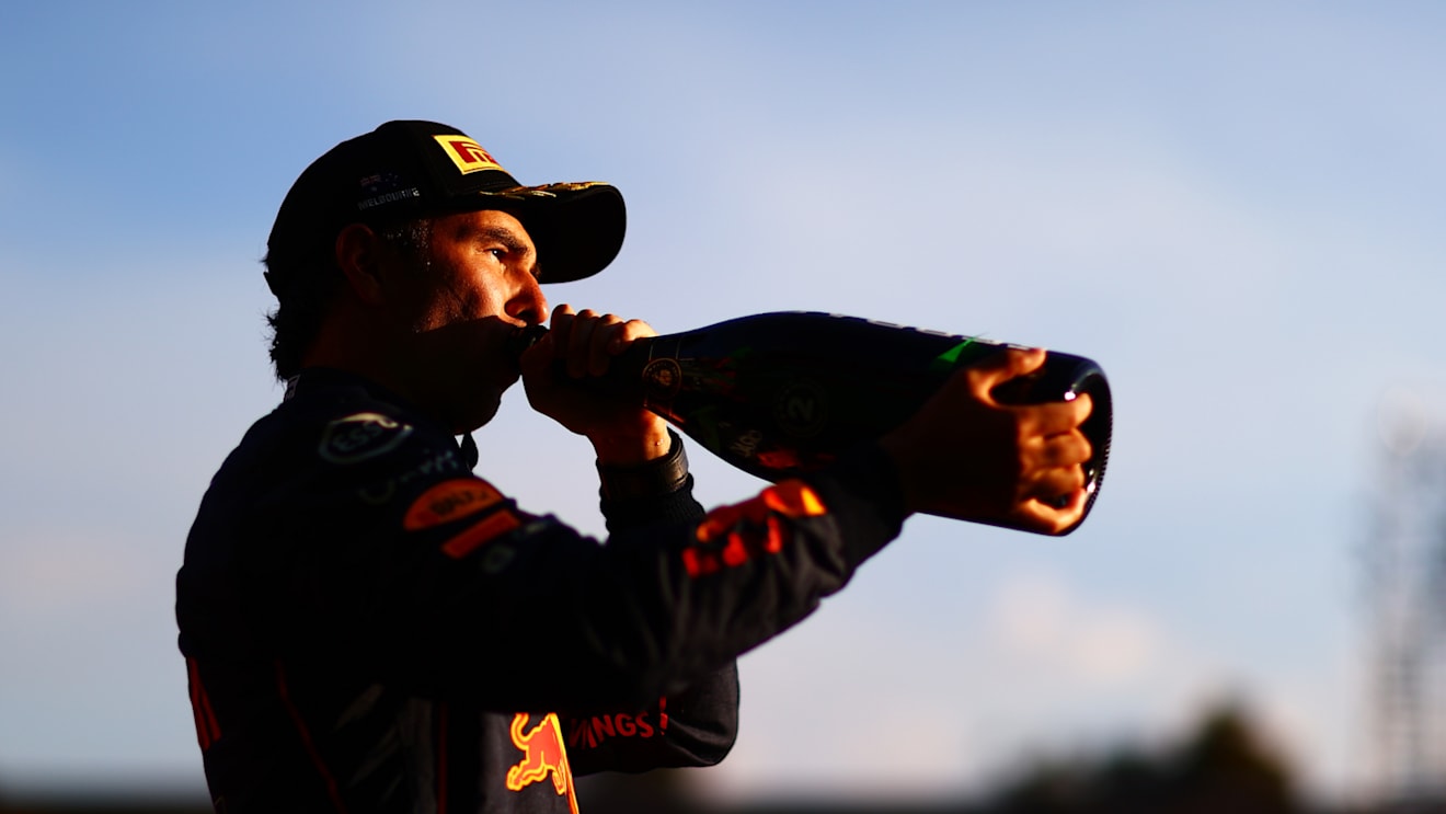 MELBOURNE, AUSTRALIA - APRIL 10: Second placed Sergio Perez of Mexico and Oracle Red Bull Racing celebrates on the podium during the F1 Grand Prix of Australia at Melbourne Grand Prix Circuit on April 10, 2022 in Melbourne, Australia. (Photo by Dan Istitene - Formula 1/Formula 1 via Getty Images)
