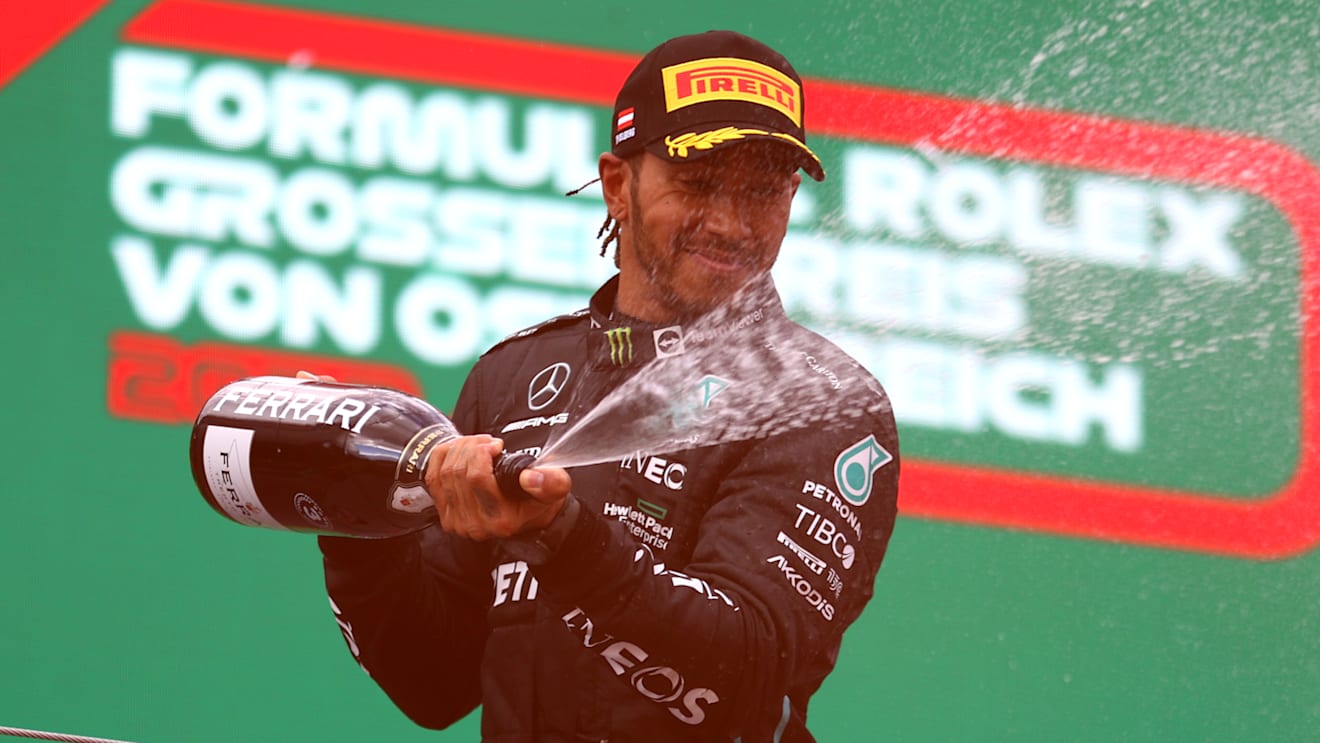 SPIELBERG, AUSTRIA - JULY 10: Third placed Lewis Hamilton of Great Britain and Mercedes celebrates on the podium during the F1 Grand Prix of Austria at Red Bull Ring on July 10, 2022 in Spielberg, Austria. (Photo by Bryn Lennon/Getty Images)