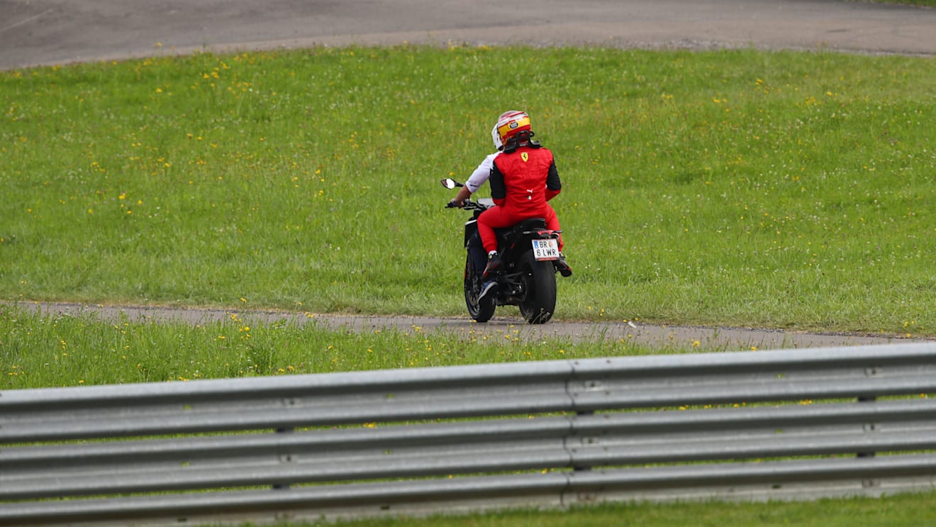 SPIELBERG, AUSTRIA - JULY 10: Carlos Sainz of Spain and Ferrari is driven back to the paddock after retiring from the race during the F1 Grand Prix of Austria at Red Bull Ring on July 10, 2022 in Spielberg, Austria. (Photo by Joe Portlock - Formula 1/Formula 1 via Getty Images)