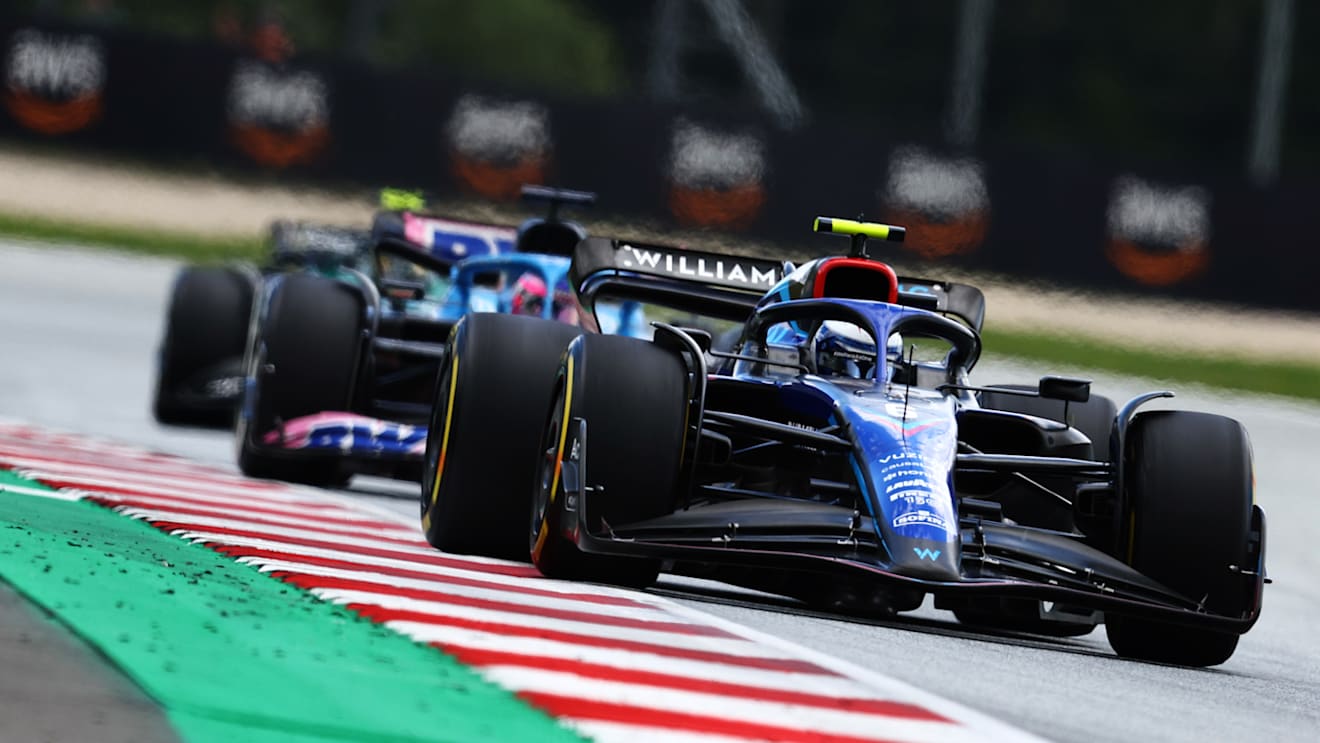 SPIELBERG, AUSTRIA - JULY 10: Nicholas Latifi of Canada driving the (6) Williams FW44 Mercedes leads Fernando Alonso of Spain driving the (14) Alpine F1 A522 Renault during the F1 Grand Prix of Austria at Red Bull Ring on July 10, 2022 in Spielberg, Austria. (Photo by Clive Rose/Getty Images)
