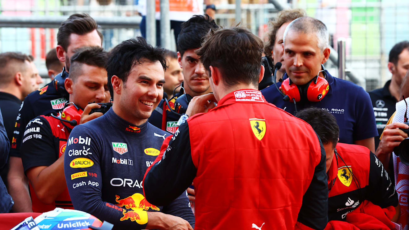BAKU, AZERBAIJAN - JUNE 11: Second placed qualifier Sergio Perez of Mexico and Oracle Red Bull Racing talks with Pole position qualifier Charles Leclerc of Monaco and Ferrari in parc ferme during qualifying ahead of the F1 Grand Prix of Azerbaijan at Baku City Circuit on June 11, 2022 in Baku, Azerbaijan. (Photo by Mark Thompson/Getty Images)