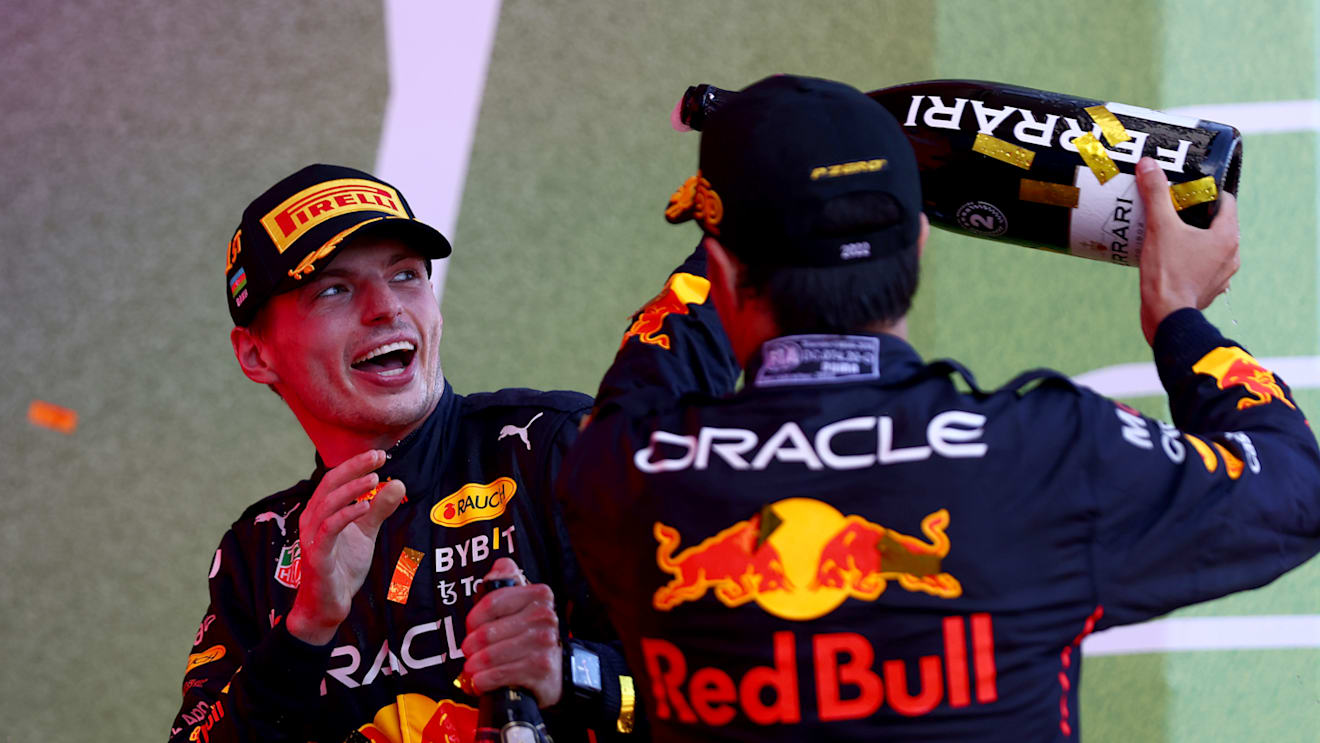 BAKU, AZERBAIJAN - JUNE 12: Race winner Max Verstappen of the Netherlands and Oracle Red Bull Racing and Second placed Sergio Perez of Mexico and Oracle Red Bull Racing celebrate on the podium during the F1 Grand Prix of Azerbaijan at Baku City Circuit on June 12, 2022 in Baku, Azerbaijan. (Photo by Dan Istitene - Formula 1/Formula 1 via Getty Images)