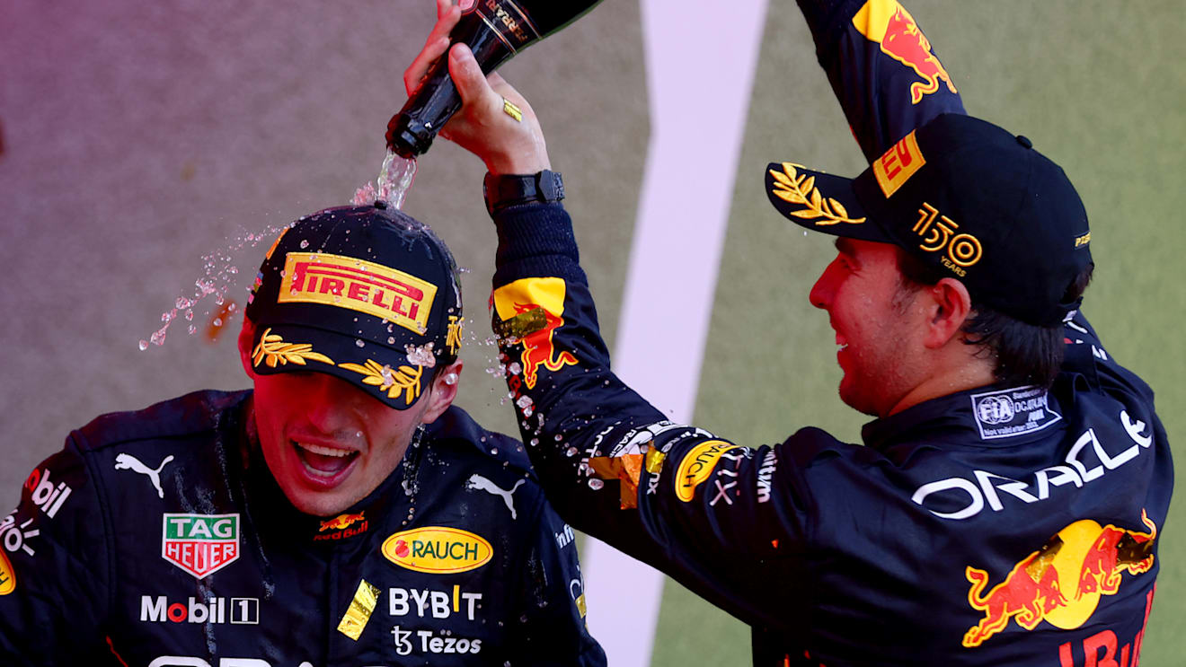 BAKU, AZERBAIJAN - JUNE 12: Race winner Max Verstappen of the Netherlands and Oracle Red Bull Racing and Second placed Sergio Perez of Mexico and Oracle Red Bull Racing celebrate on the podium during the F1 Grand Prix of Azerbaijan at Baku City Circuit on June 12, 2022 in Baku, Azerbaijan. (Photo by Dan Istitene - Formula 1/Formula 1 via Getty Images)