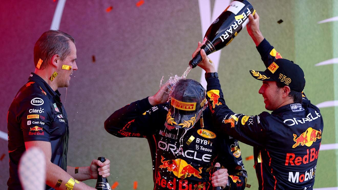 BAKU, AZERBAIJAN - JUNE 12: Race winner Max Verstappen of the Netherlands and Oracle Red Bull Racing, Second placed Sergio Perez of Mexico and Oracle Red Bull Racing and Tom Hart, Performance Engineer at Red Bull Racing celebrate on the podium during the F1 Grand Prix of Azerbaijan at Baku City Circuit on June 12, 2022 in Baku, Azerbaijan. (Photo by Dan Istitene - Formula 1/Formula 1 via Getty Images)