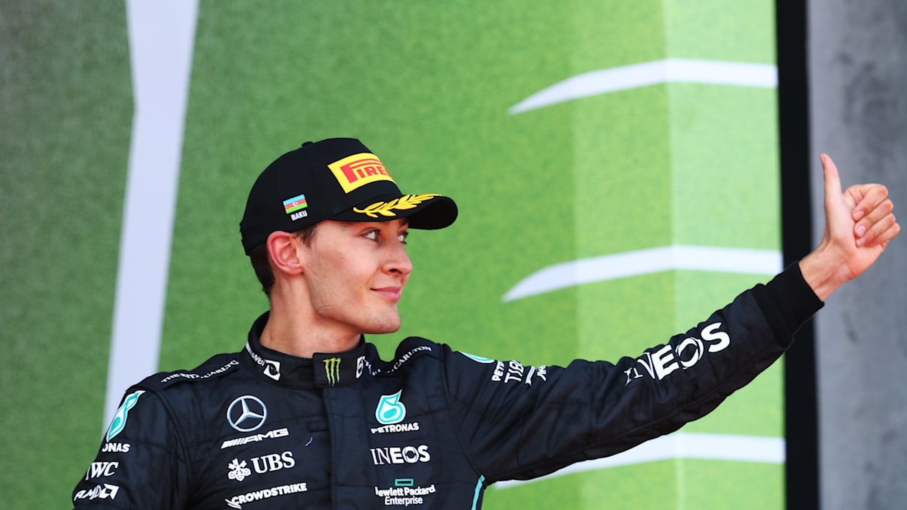 BAKU, AZERBAIJAN - JUNE 12: Third placed George Russell of Great Britain and Mercedes celebrates on the podium during the F1 Grand Prix of Azerbaijan at Baku City Circuit on June 12, 2022 in Baku, Azerbaijan. (Photo by Clive Rose/Getty Images)