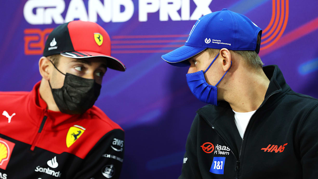BAHRAIN, BAHRAIN - MARCH 18: Mick Schumacher of Germany and Haas F1 talks with Charles Leclerc of Monaco and Ferrari in the Drivers Press Conference before practice ahead of the F1 Grand Prix of Bahrain at Bahrain International Circuit on March 18, 2022 in Bahrain, Bahrain. (Photo by Clive Rose/Getty Images)