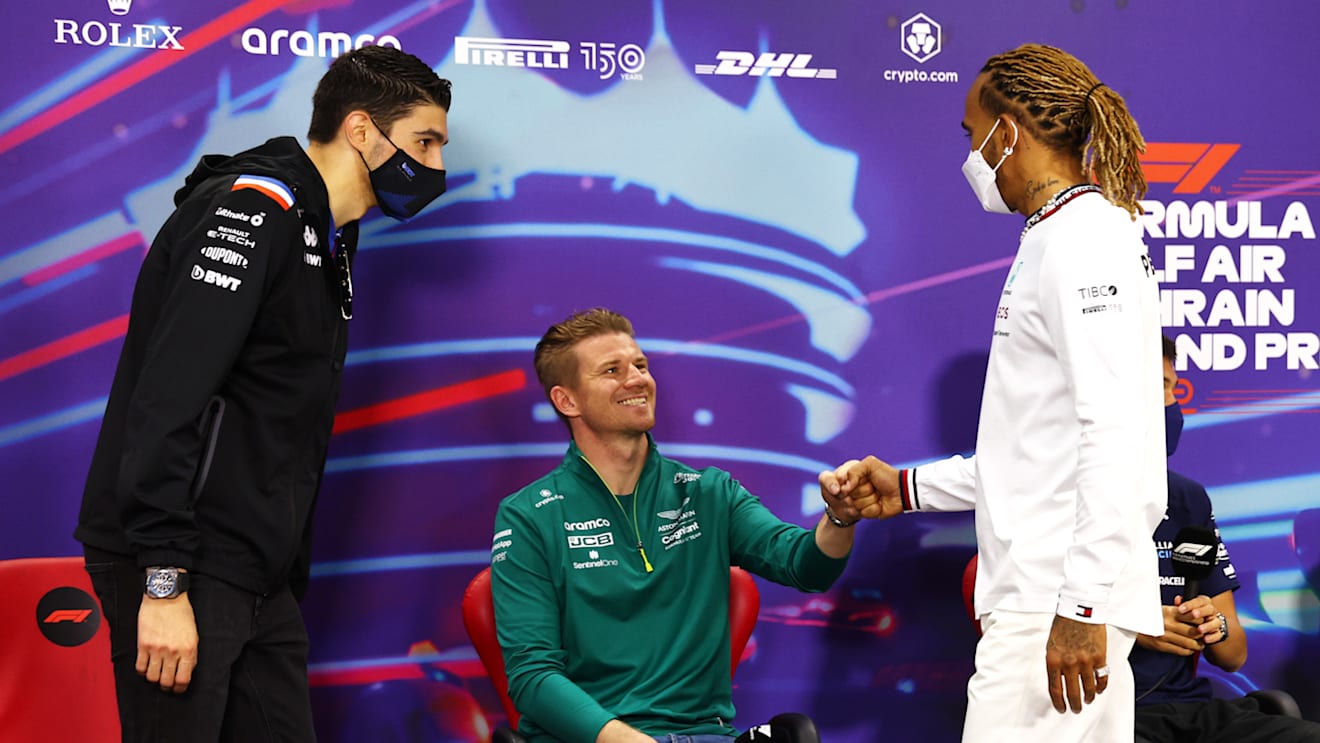 BAHRAIN, BAHRAIN - MARCH 18: Lewis Hamilton of Great Britain and Mercedes (R) and Esteban Ocon of France and Alpine F1 (L) greet Nico Hulkenberg of Germany and Aston Martin F1 Team (C) to the Drivers Press Conference before practice ahead of the F1 Grand Prix of Bahrain at Bahrain International Circuit on March 18, 2022 in Bahrain, Bahrain. (Photo by Lars Baron/Getty Images)