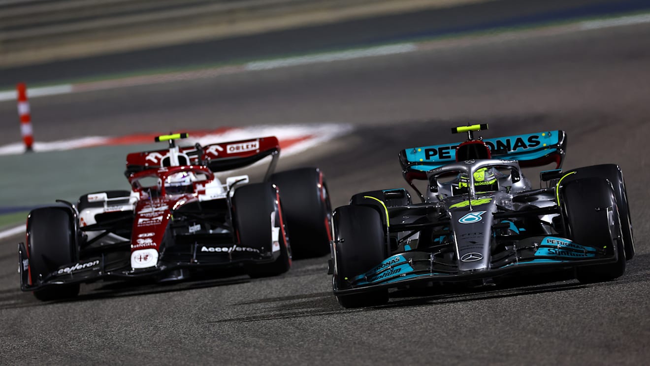 BAHRAIN, BAHRAIN - MARCH 20: Lewis Hamilton of Great Britain driving the (44) Mercedes AMG Petronas F1 Team W13 leads Zhou Guanyu of China driving the (24) Alfa Romeo F1 C42 Ferrari during the F1 Grand Prix of Bahrain at Bahrain International Circuit on March 20, 2022 in Bahrain, Bahrain. (Photo by Lars Baron/Getty Images)