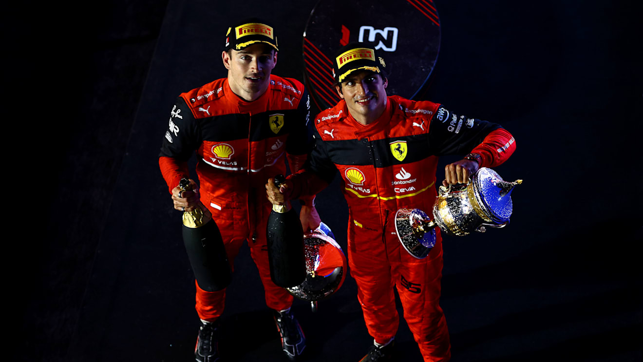 BAHRAIN, BAHRAIN - MARCH 20: Race winner Charles Leclerc of Monaco and Ferrari and Second placed Carlos Sainz of Spain and Ferrari celebrate on the podium during the F1 Grand Prix of Bahrain at Bahrain International Circuit on March 20, 2022 in Bahrain, Bahrain. (Photo by Mark Thompson/Getty Images)