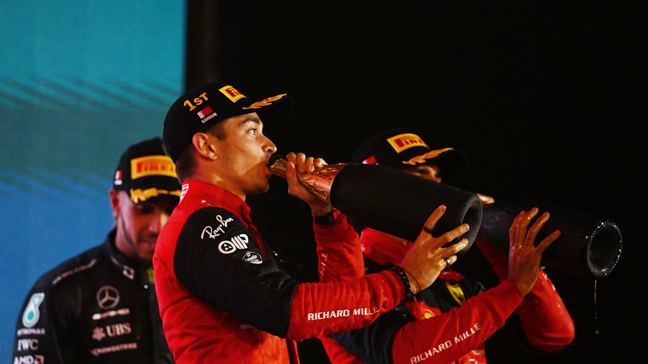 BAHRAIN, BAHRAIN - MARCH 20: Race winner Charles Leclerc of Monaco and Ferrari celebrates on the podium during the F1 Grand Prix of Bahrain at Bahrain International Circuit on March 20, 2022 in Bahrain, Bahrain. (Photo by Clive Mason/Getty Images)