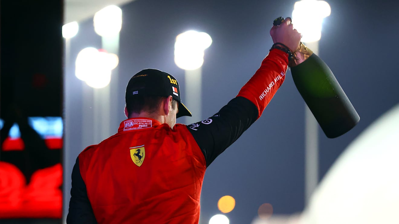 BAHRAIN, BAHRAIN - MARCH 20: Race winner Charles Leclerc of Monaco and Ferrari celebrates on the podium during the F1 Grand Prix of Bahrain at Bahrain International Circuit on March 20, 2022 in Bahrain, Bahrain. (Photo by Dan Istitene - Formula 1/Formula 1 via Getty Images)