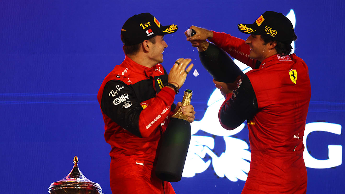 BAHRAIN, BAHRAIN - MARCH 20: Race winner Charles Leclerc of Monaco and Ferrari and Second placed Carlos Sainz of Spain and Ferrari celebrate on the podium during the F1 Grand Prix of Bahrain at Bahrain International Circuit on March 20, 2022 in Bahrain, Bahrain. (Photo by Lars Baron/Getty Images)