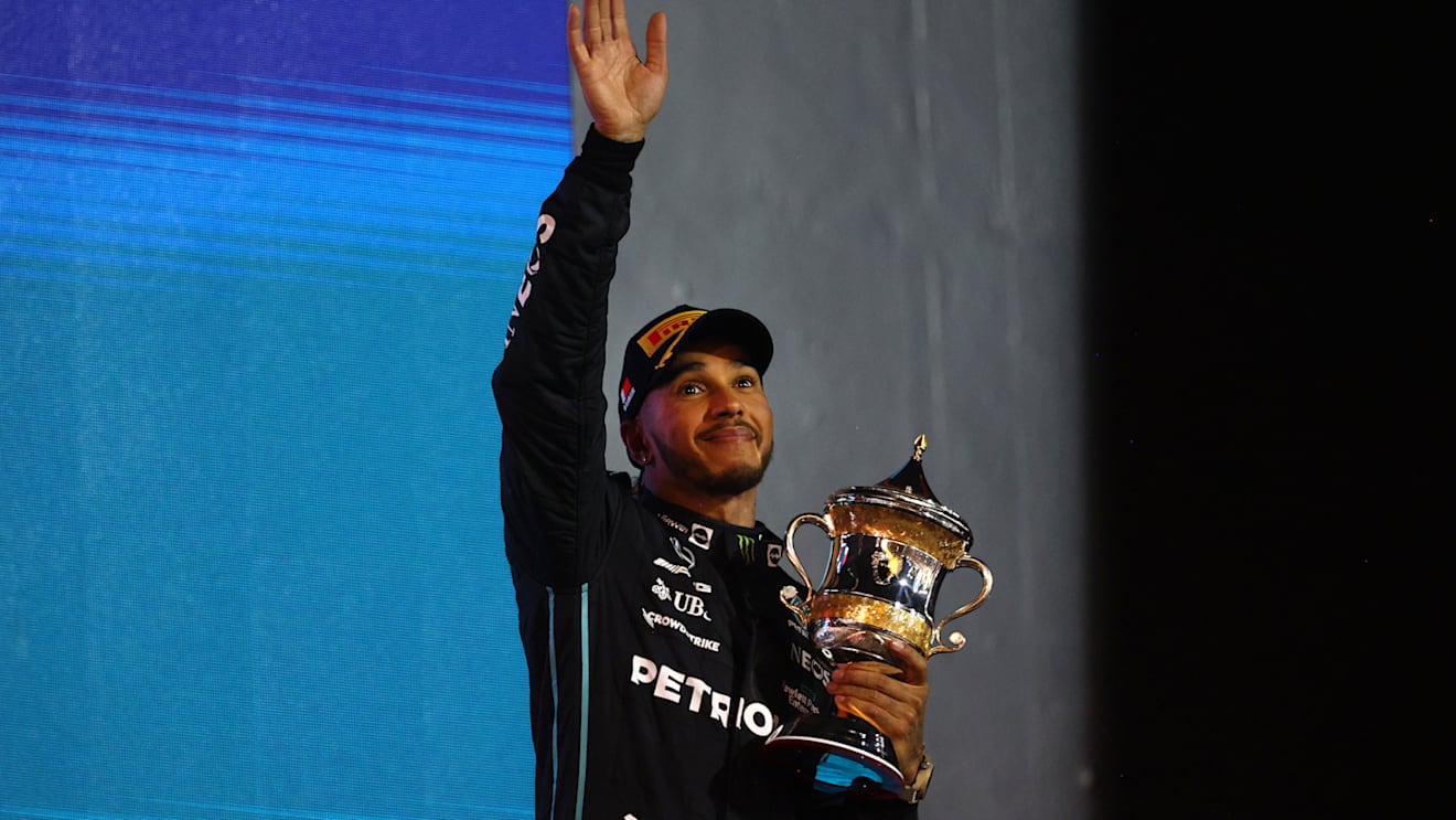 BAHRAIN, BAHRAIN - MARCH 20: Third placed Lewis Hamilton of Great Britain and Mercedes celebrates on the podium during the F1 Grand Prix of Bahrain at Bahrain International Circuit on March 20, 2022 in Bahrain, Bahrain. (Photo by Clive Rose - Formula 1/Formula 1 via Getty Images)