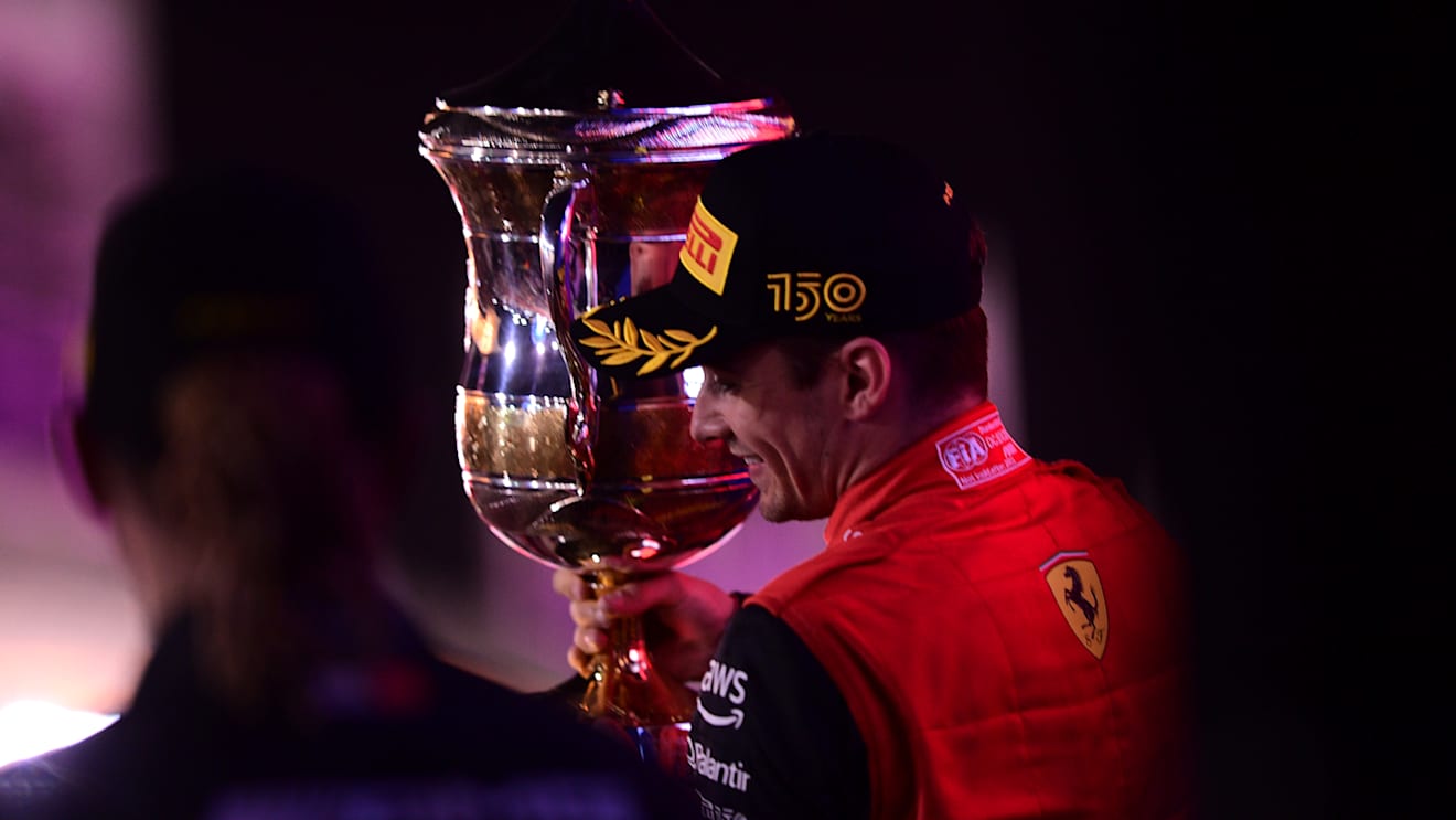 BAHRAIN, BAHRAIN - MARCH 20: Race winner Charles Leclerc of Monaco and Ferrari celebrates on the podium during the F1 Grand Prix of Bahrain at Bahrain International Circuit on March 20, 2022 in Bahrain, Bahrain. (Photo by Mario Renzi - Formula 1/Formula 1 via Getty Images)