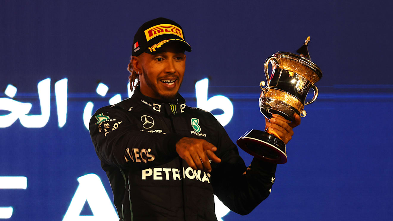 BAHRAIN, BAHRAIN - MARCH 20: Third placed Lewis Hamilton of Great Britain and Mercedes celebrates on the podium during the F1 Grand Prix of Bahrain at Bahrain International Circuit on March 20, 2022 in Bahrain, Bahrain. (Photo by Lars Baron/Getty Images)