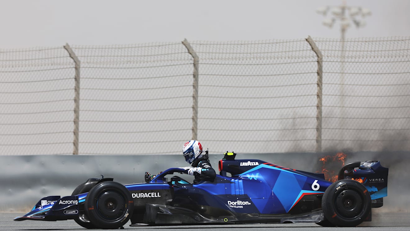 BAHRAIN, BAHRAIN - MARCH 11: Nicholas Latifi of Canada and Williams climbs from his car as his rear brakes catch fire during Day Two of F1 Testing at Bahrain International Circuit on March 11, 2022 in Bahrain, Bahrain. (Photo by Mark Thompson/Getty Images)