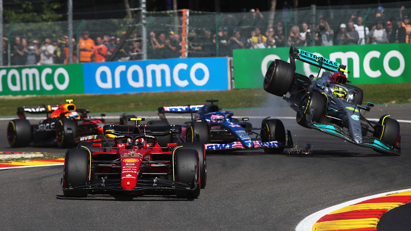 SPA, BELGIUM - AUGUST 28: Carlos Sainz of Spain driving (55) the Ferrari F1-75 leads the field as Fernando Alonso of Spain driving the (14) Alpine F1 A522 Renault and Lewis Hamilton of Great Britain driving the (44) Mercedes AMG Petronas F1 Team W13 crash during the F1 Grand Prix of Belgium at Circuit de Spa-Francorchamps on August 28, 2022 in Spa, Belgium. (Photo by Joe Portlock - Formula 1/Formula 1 via Getty Images)