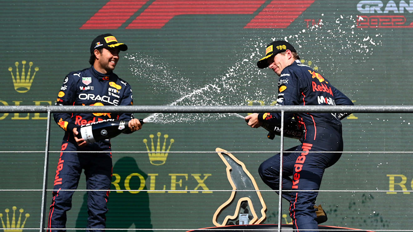 SPA, BELGIUM - AUGUST 28: Race winner Max Verstappen of the Netherlands and Oracle Red Bull Racing and Second placed Sergio Perez of Mexico and Oracle Red Bull Racing celebrate on the podium during the F1 Grand Prix of Belgium at Circuit de Spa-Francorchamps on August 28, 2022 in Spa, Belgium. (Photo by Dan Mullan/Getty Images)