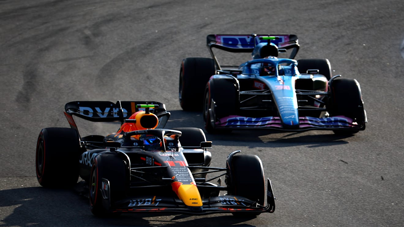 SAO PAULO, BRAZIL - NOVEMBER 12: Sergio Perez of Mexico driving the (11) Oracle Red Bull Racing RB18 leads Esteban Ocon of France driving the (31) Alpine F1 A522 Renault during the Sprint ahead of the F1 Grand Prix of Brazil at Autodromo Jose Carlos Pace on November 12, 2022 in Sao Paulo, Brazil. (Photo by Jared C. Tilton/Getty Images)