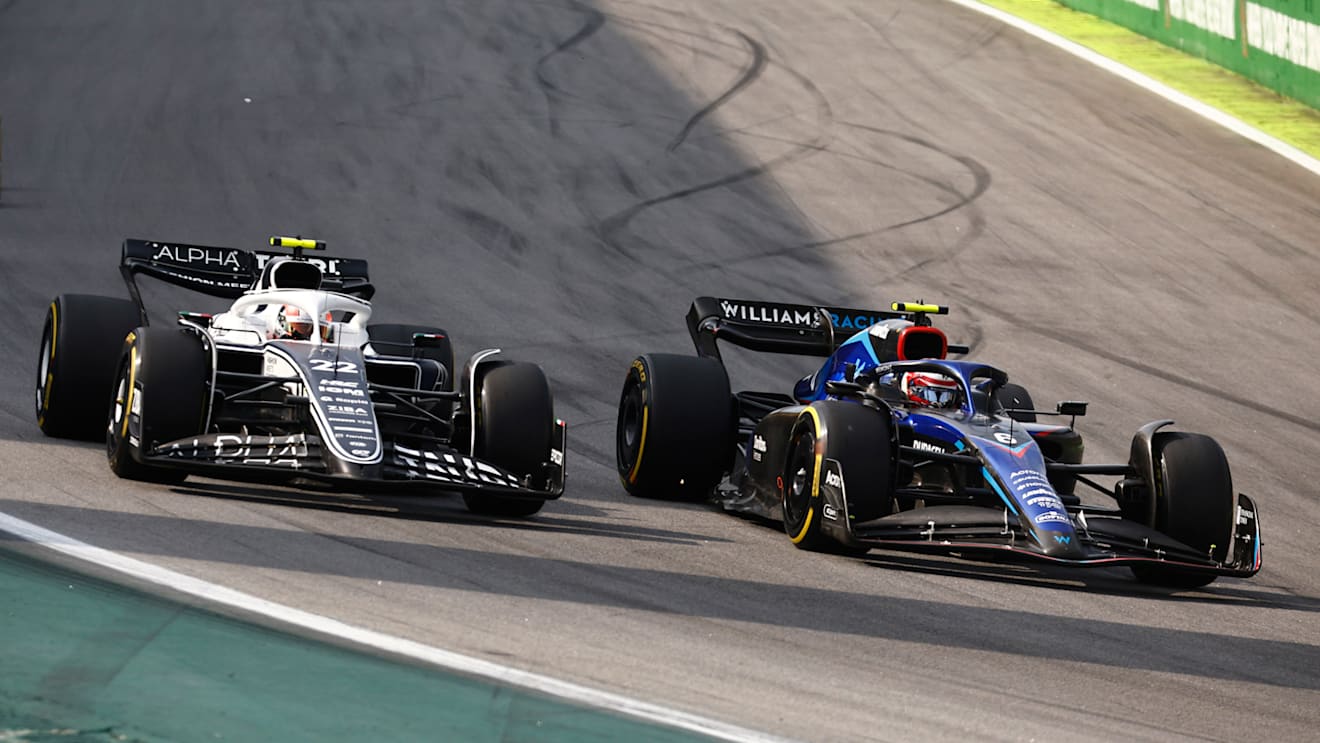 SAO PAULO, BRAZIL - NOVEMBER 13: Yuki Tsunoda of Japan driving the (22) Scuderia AlphaTauri AT03 and Nicholas Latifi of Canada driving the (6) Williams FW44 Mercedes battle for track position during the F1 Grand Prix of Brazil at Autodromo Jose Carlos Pace on November 13, 2022 in Sao Paulo, Brazil. (Photo by Chris Graythen/Getty Images)