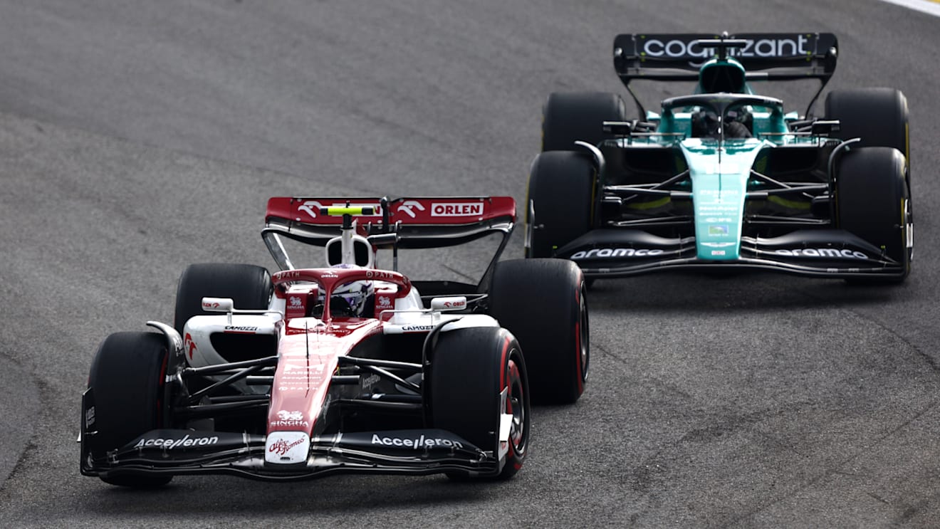 SAO PAULO, BRAZIL - NOVEMBER 13: Zhou Guanyu of China driving the (24) Alfa Romeo F1 C42 Ferrari leads Lance Stroll of Canada driving the (18) Aston Martin AMR22 Mercedes during the F1 Grand Prix of Brazil at Autodromo Jose Carlos Pace on November 13, 2022 in Sao Paulo, Brazil. (Photo by Bryn Lennon - Formula 1/Formula 1 via Getty Images)