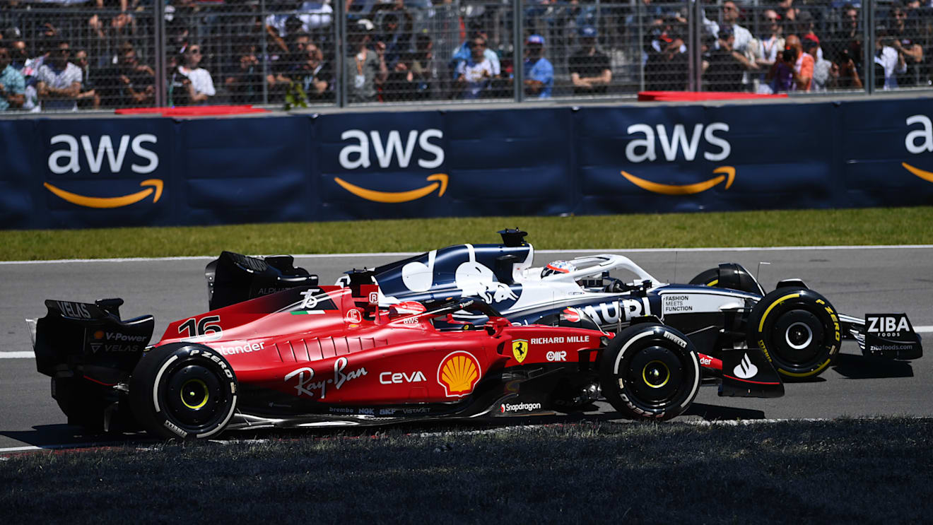MONTREAL, QUEBEC - JUNE 19: Pierre Gasly of France driving the (10) Scuderia AlphaTauri AT03 leads Charles Leclerc of Monaco driving the (16) Ferrari F1-75 during the F1 Grand Prix of Canada at Circuit Gilles Villeneuve on June 19, 2022 in Montreal, Quebec. (Photo by Dan Mullan/Getty Images)