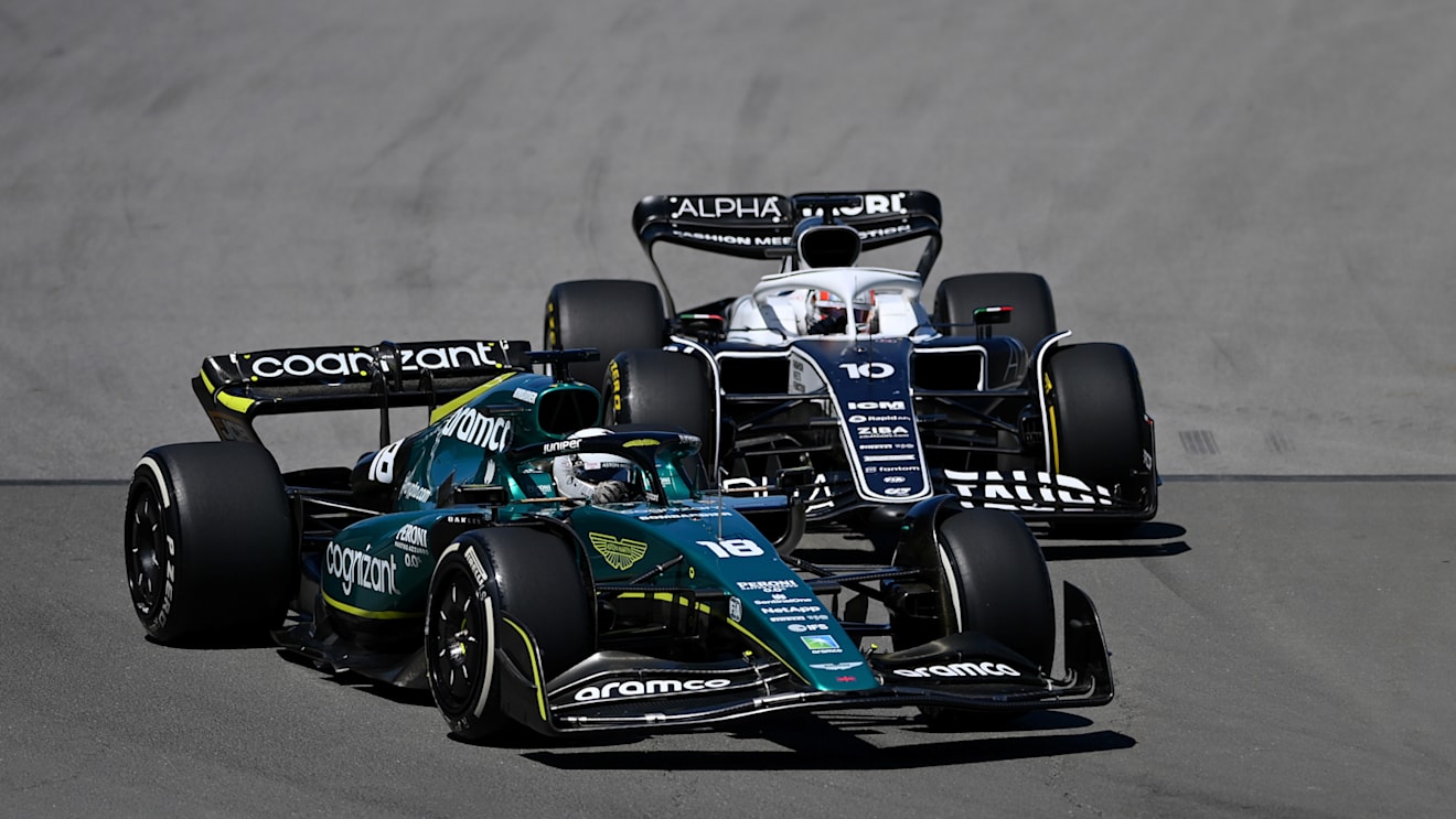 MONTREAL, QUEBEC - JUNE 19: Lance Stroll of Canada driving the (18) Aston Martin AMR22 Mercedes leads Pierre Gasly of France driving the (10) Scuderia AlphaTauri AT03 during the F1 Grand Prix of Canada at Circuit Gilles Villeneuve on June 19, 2022 in Montreal, Quebec. (Photo by Dan Mullan/Getty Images)