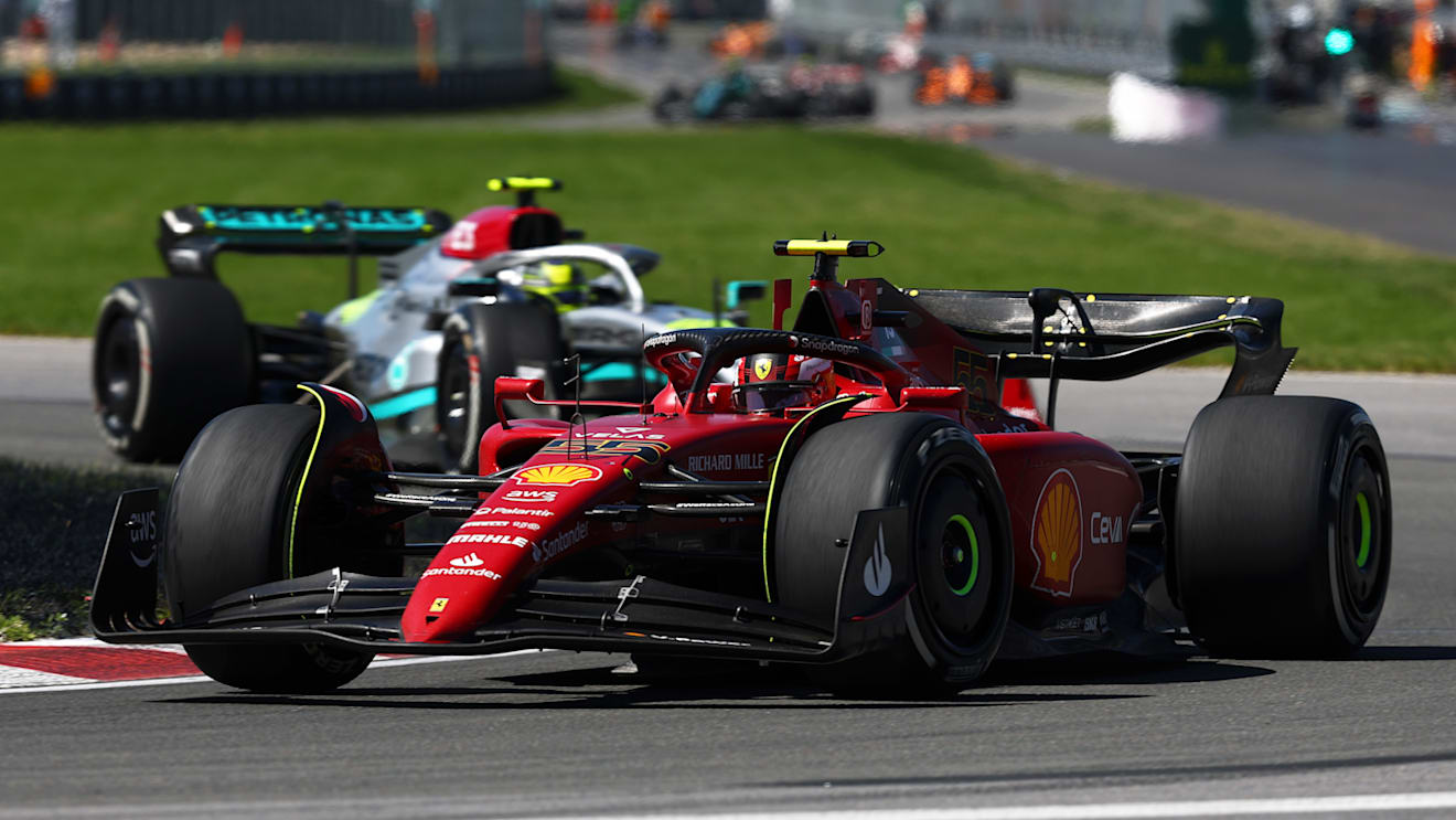 MONTREAL, QUEBEC - JUNE 19: Carlos Sainz of Spain driving (55) the Ferrari F1-75 leads Lewis Hamilton of Great Britain driving the (44) Mercedes AMG Petronas F1 Team W13 during the F1 Grand Prix of Canada at Circuit Gilles Villeneuve on June 19, 2022 in Montreal, Quebec. (Photo by Lars Baron - Formula 1/Formula 1 via Getty Images)
