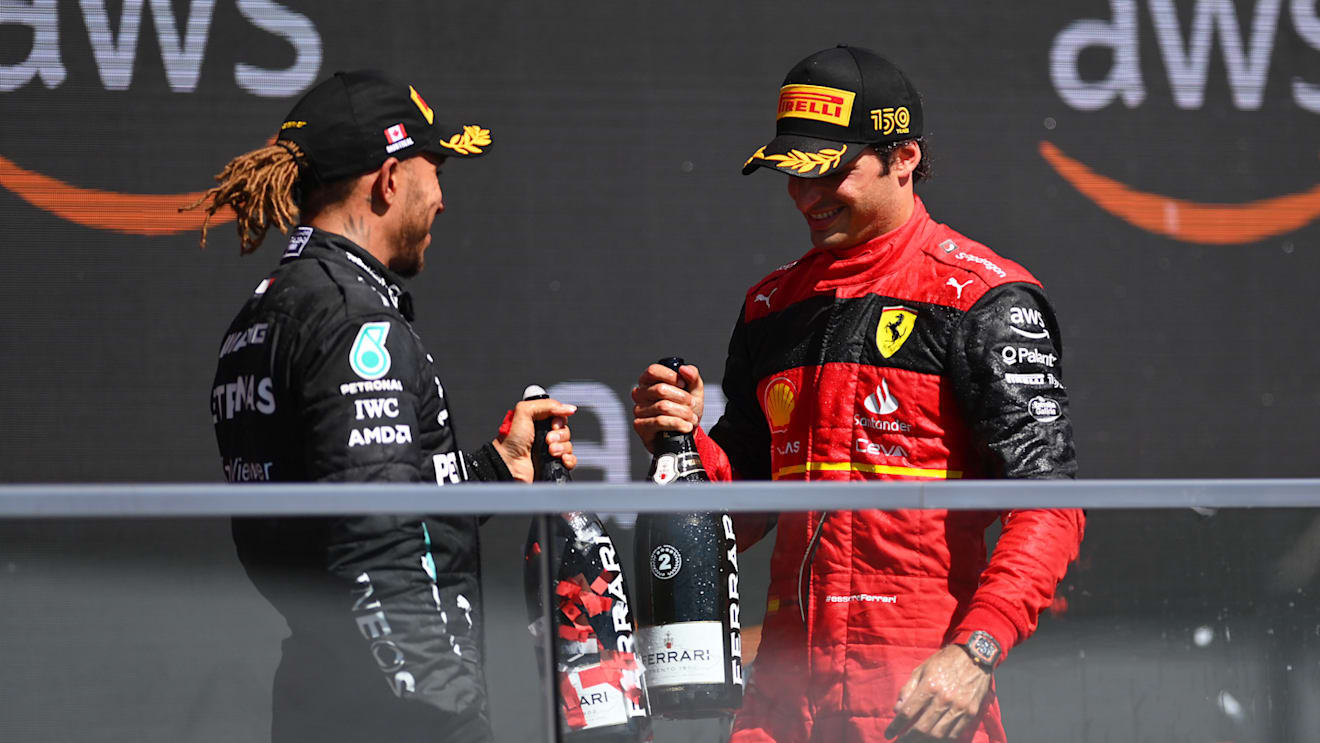 MONTREAL, QUEBEC - JUNE 19: Second placed Carlos Sainz of Spain and Ferrari and Third placed Lewis Hamilton of Great Britain and Mercedes celebrate on the podium during the F1 Grand Prix of Canada at Circuit Gilles Villeneuve on June 19, 2022 in Montreal, Quebec. (Photo by Dan Mullan/Getty Images)