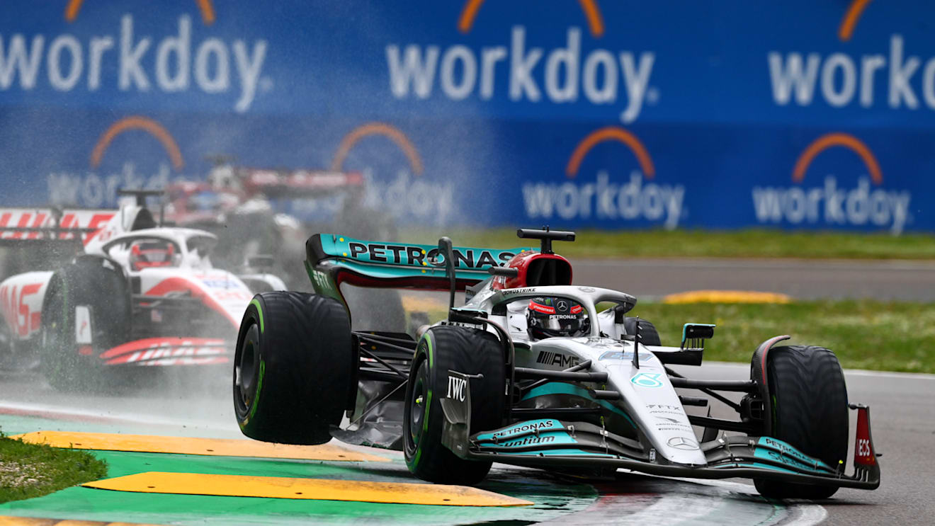 IMOLA, ITALY - APRIL 24: George Russell of Great Britain driving the (63) Mercedes AMG Petronas F1 Team W13 runs wide as he defends track position from Kevin Magnussen of Denmark driving the (20) Haas F1 VF-22 Ferrari during the F1 Grand Prix of Emilia Romagna at Autodromo Enzo e Dino Ferrari on April 24, 2022 in Imola, Italy. (Photo by Dan Mullan/Getty Images)