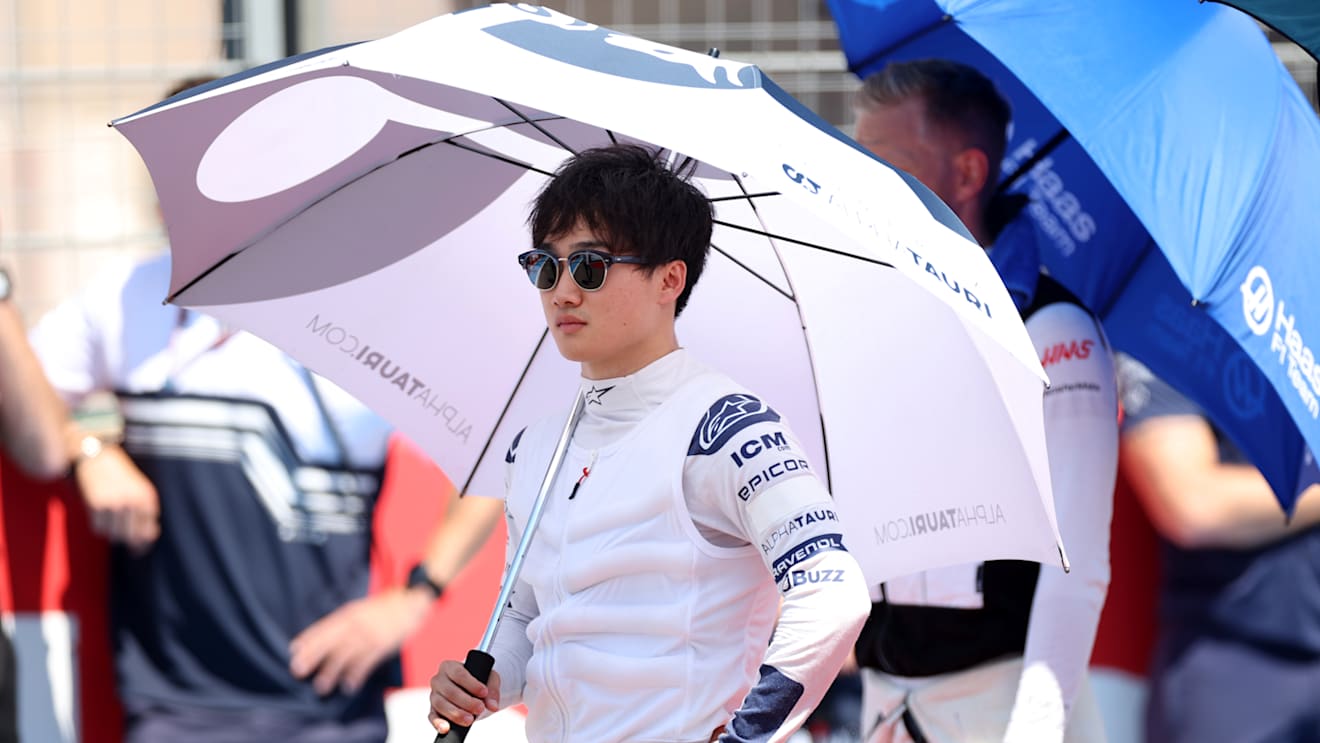 LE CASTELLET, FRANCE - JULY 24: Yuki Tsunoda of Japan and Scuderia AlphaTauri stands for the national anthem on the grid during the F1 Grand Prix of France at Circuit Paul Ricard on July 24, 2022 in Le Castellet, France. (Photo by Peter Fox/Getty Images)