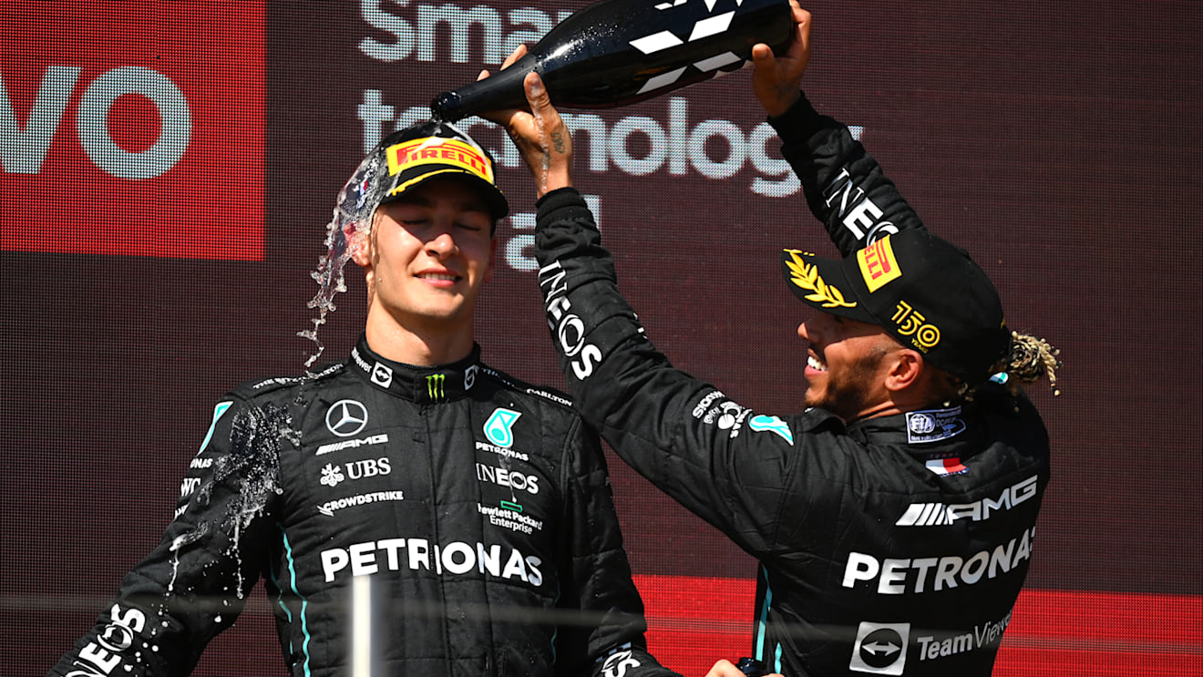 LE CASTELLET, FRANCE - JULY 24: Second placed Lewis Hamilton of Great Britain and Mercedes and Third placed George Russell of Great Britain and Mercedes celebrate on the podium during the F1 Grand Prix of France at Circuit Paul Ricard on July 24, 2022 in Le Castellet, France. (Photo by Dan Mullan/Getty Images)